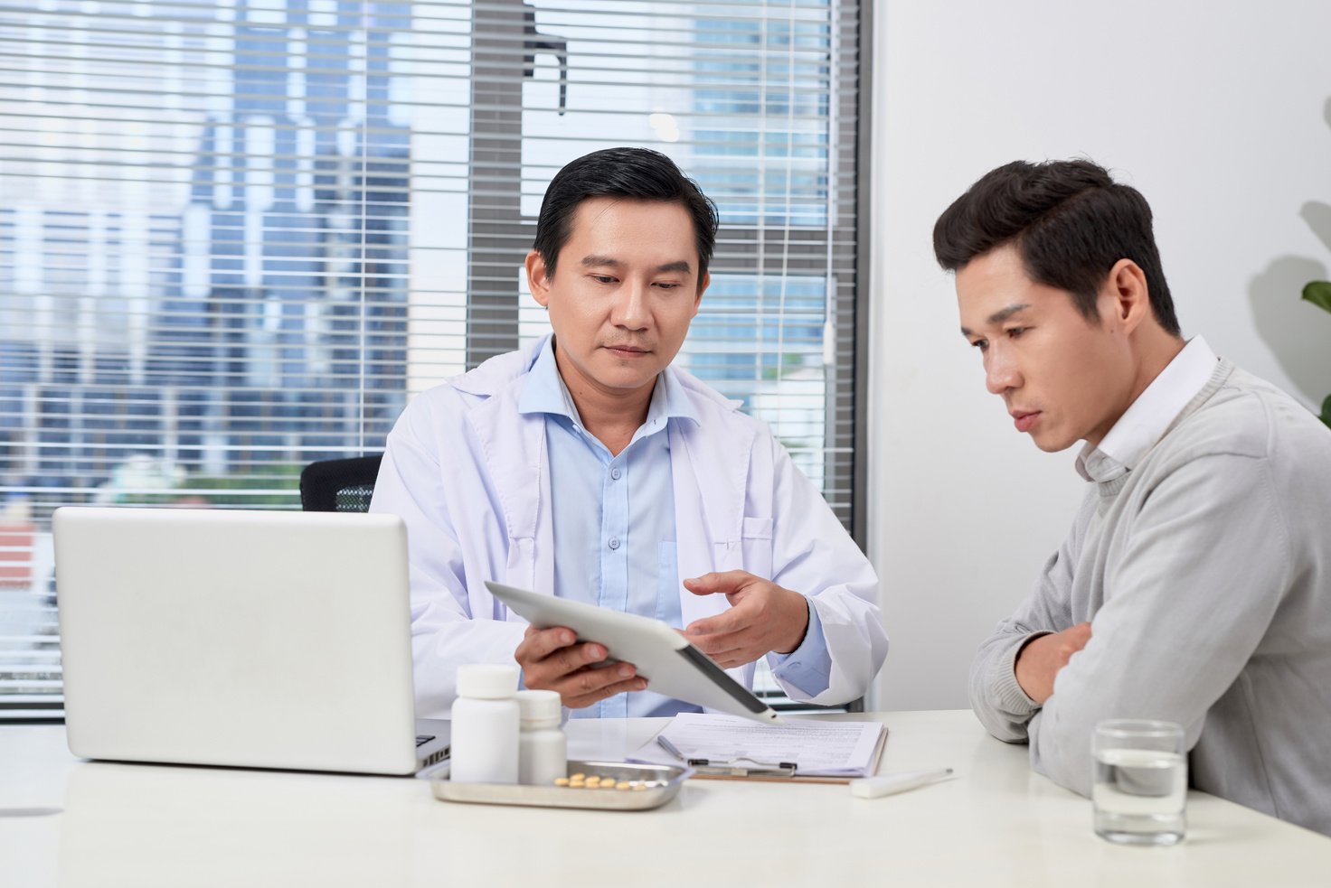 Asian doctor consults young patient