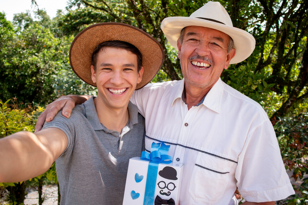 Father and son taking a selfie on father's day. Latin